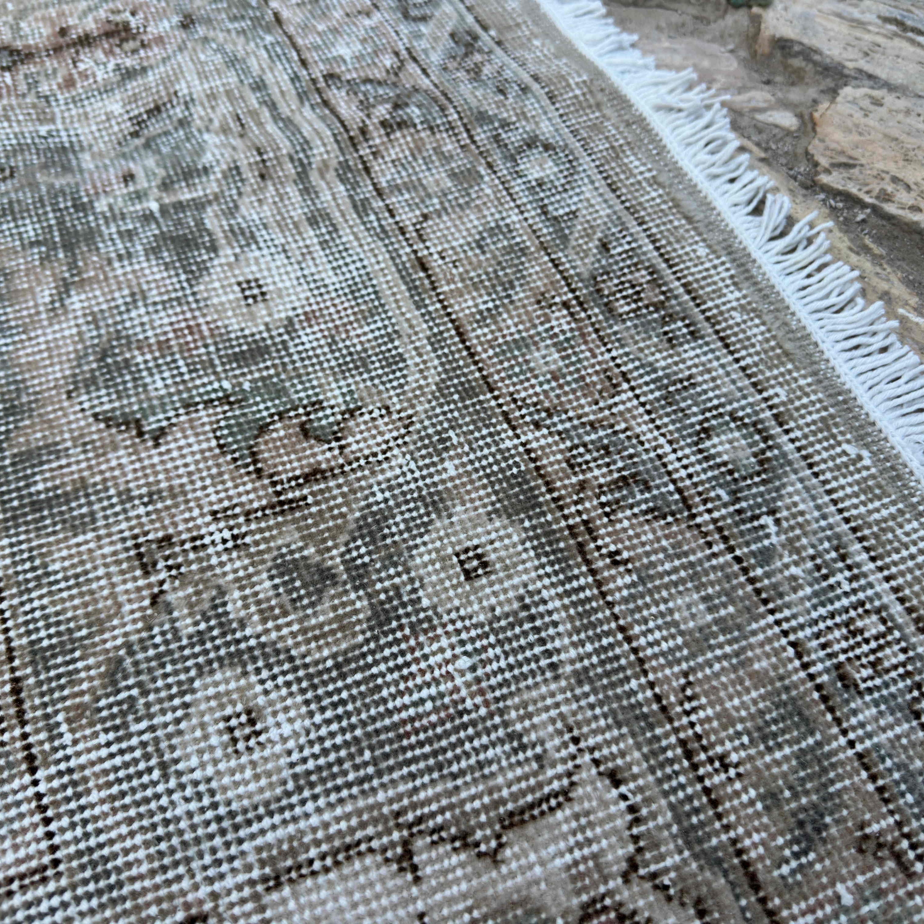 Close-up of the brown vintage Turkish large rug showing medallion details, hand-knotted weave, wool and cotton and low pile.