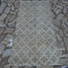 Beige 3' x 7' vintage Turkish low pile rug in wool and cotton, shown on the floor.