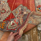 Close-up of the red vintage Turkish medallion carpet showing medallion details, hand-knotted weave, wool and low pile.