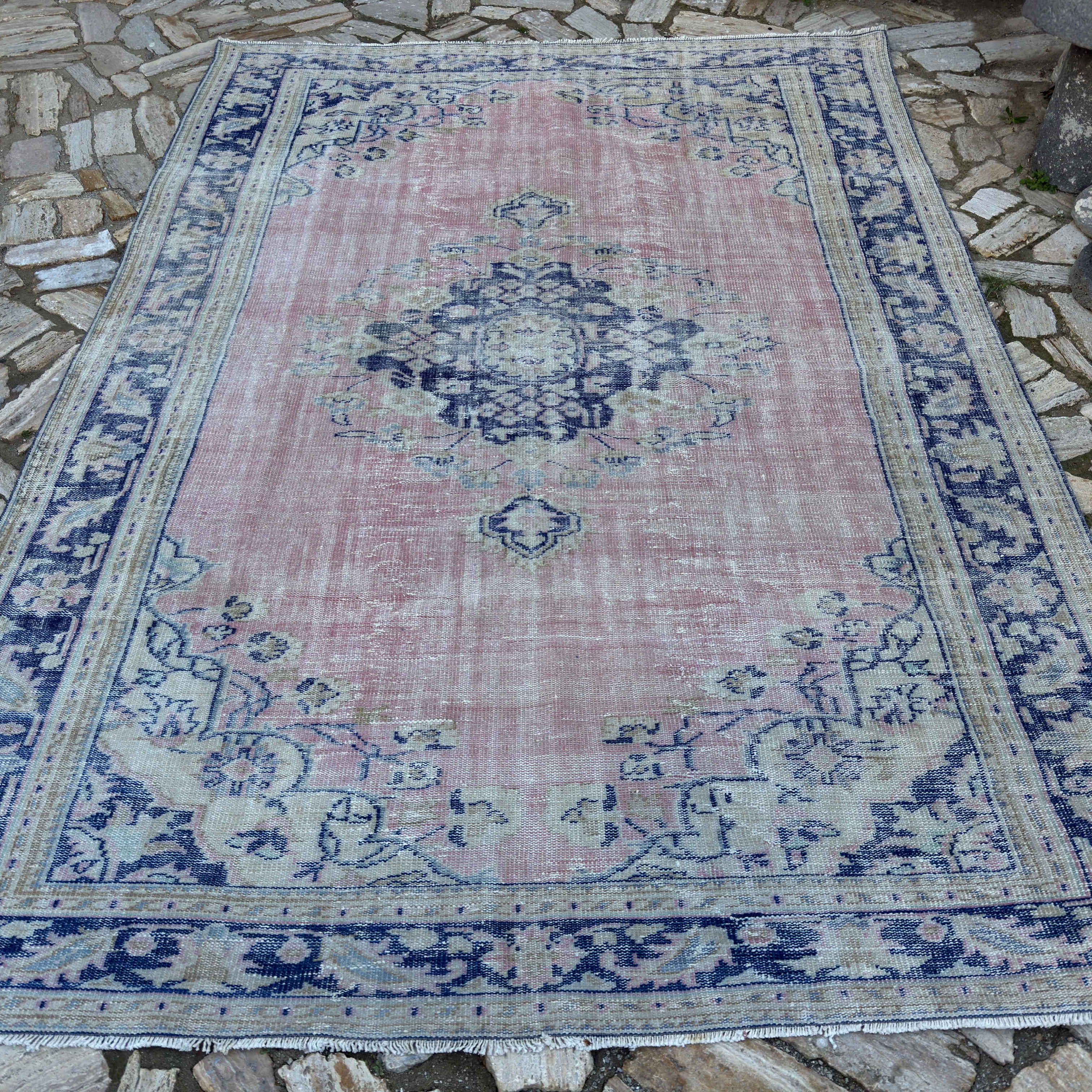 Pale Pink 7' x 10' vintage Turkish medallion carpet in wool and cotton, shown on the floor.