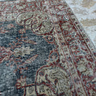 Close-up of the blue vintage Turkish medallion rug showing traditional details, hand-knotted weave, wool and cotton and low pile.
