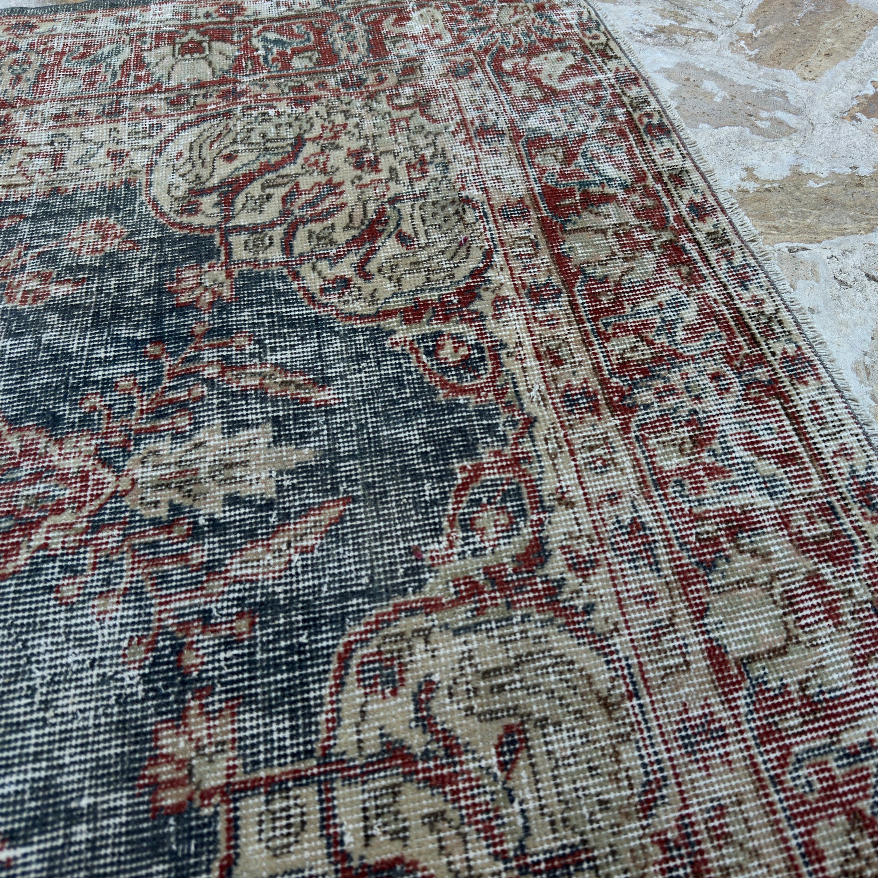 Close-up of the blue vintage Turkish medallion rug showing traditional details, hand-knotted weave, wool and cotton and low pile.