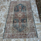 Blue 4' x 7' vintage Turkish medallion rug in wool and cotton, shown on the floor.