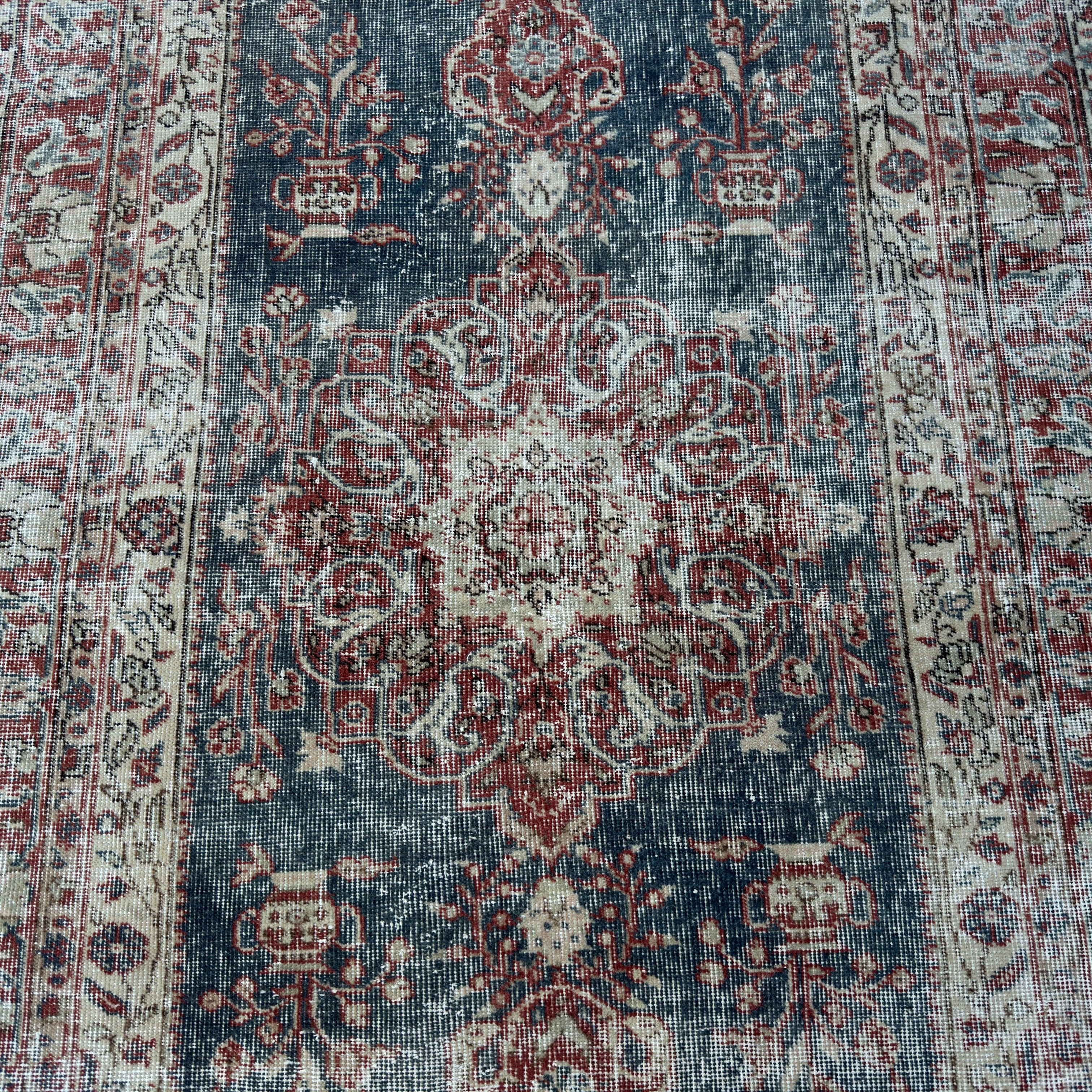 1970s blue vintage Turkish medallion rug with traditional design, hand-knotted weave and low pile.