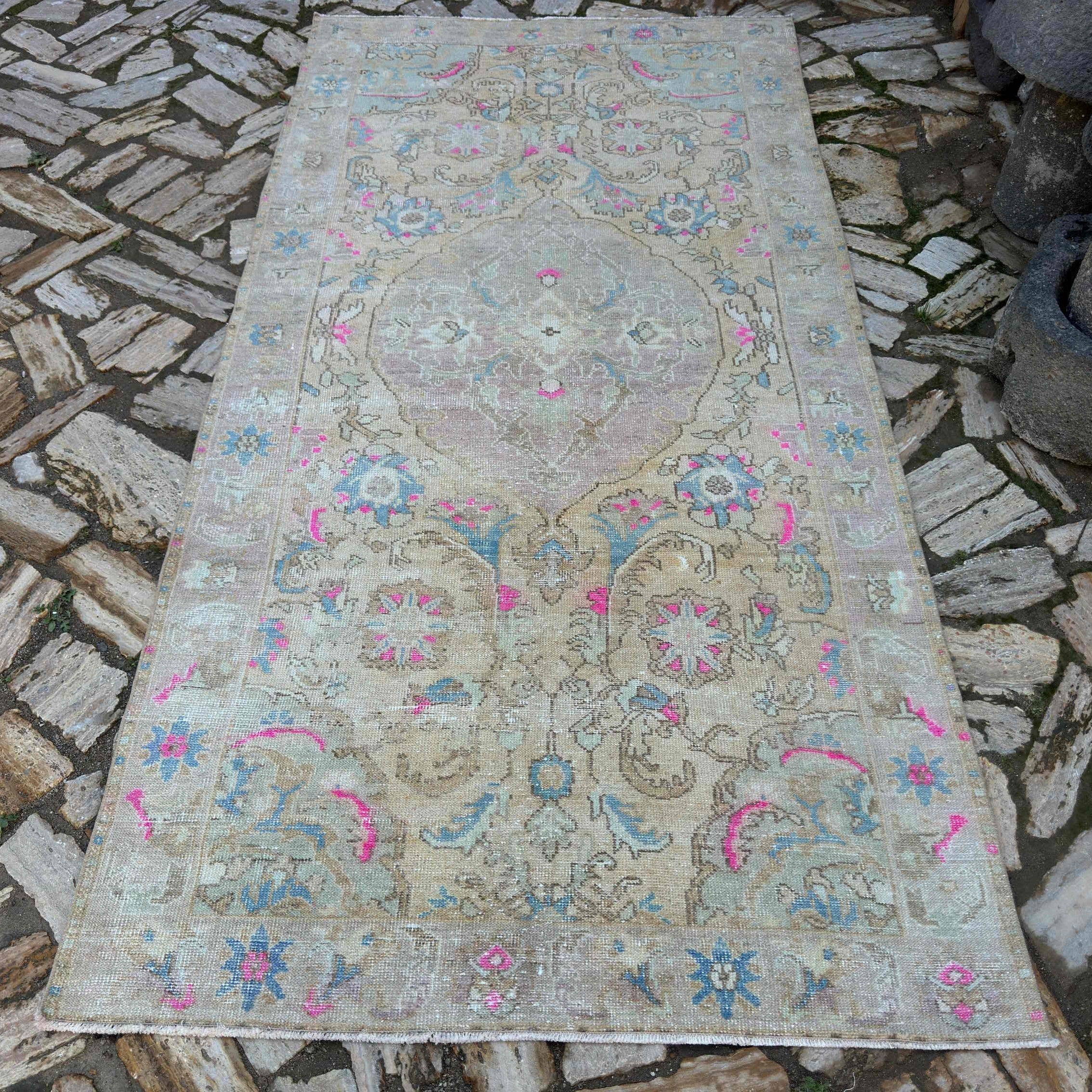 Pink 4' x 9' vintage Turkish medallion rug in wool and cotton, shown on the floor.