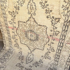 Beige 5' x 10' vintage Turkish medallion rug in wool and cotton, shown on the floor.