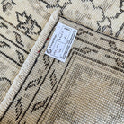 1970s beige vintage Turkish medallion rug with neutral design, hand-knotted weave and low pile.