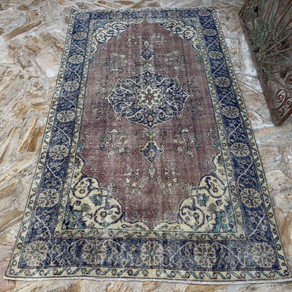 Close-up of the blue vintage Turkish medallion rug showing medallion details, hand-knotted weave, wool and cotton and low pile.