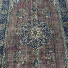 Blue 5' x 8' vintage Turkish medallion rug in wool and cotton, shown on the floor.