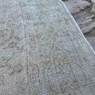Close-up of the beige vintage Turkish medallion rug showing neutral details, hand-knotted weave, wool and cotton and low pile.