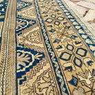 Close-up of the blue vintage Turkish medallion rug showing geometric details, hand-knotted weave, wool and cotton and low pile.