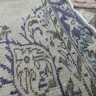 Close-up of the blue vintage Turkish medallion rug showing medallion details, hand-knotted weave, wool and cotton and low pile.