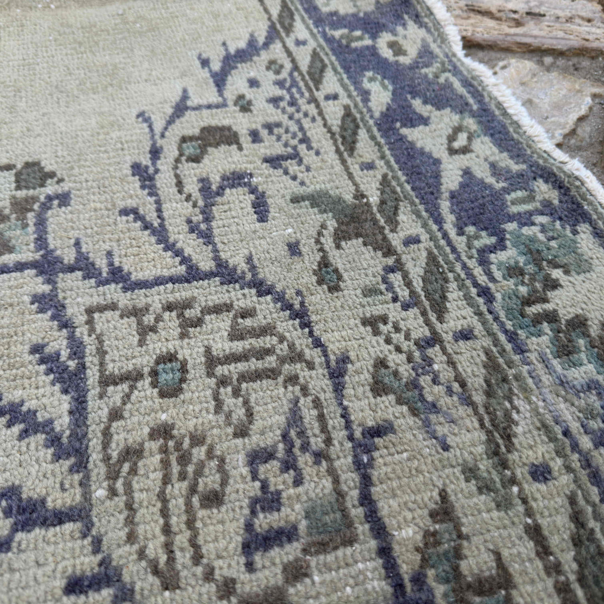 Close-up of the blue vintage Turkish medallion rug showing medallion details, hand-knotted weave, wool and cotton and low pile.