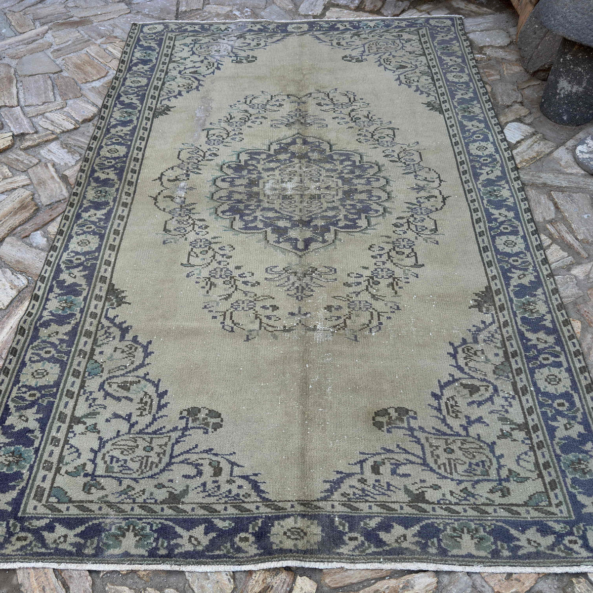 Blue 6' x 9' vintage Turkish medallion rug in wool and cotton, shown on the floor.