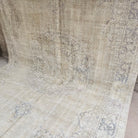 Blue 8' x 12' vintage Turkish medallion rug in wool and cotton, shown on the floor.
