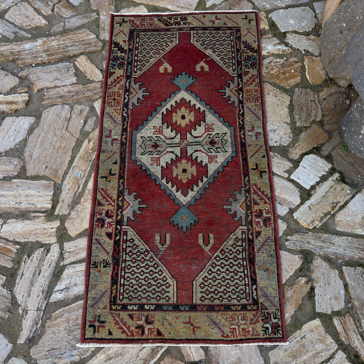 Red 2' x 5' vintage Turkish medium size rug in wool and cotton, shown on the floor.