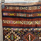 Brown 2' x 6' vintage mini kilim runner rug in wool and cotton, shown on the floor.