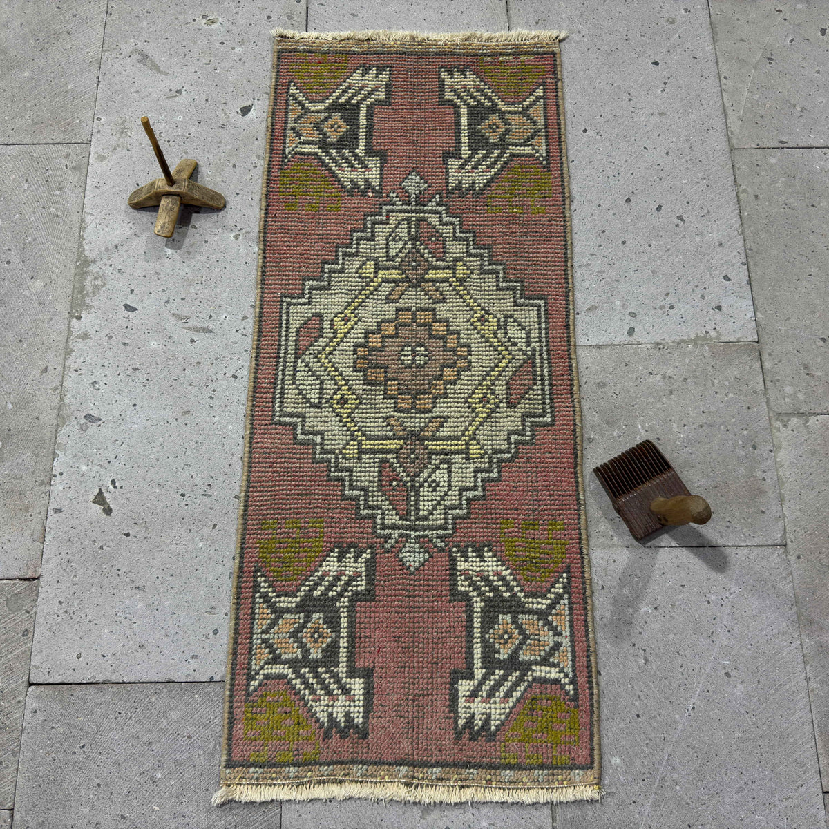 Red 1' x 3' vintage Turkish mini rug in wool and cotton, shown on the floor.