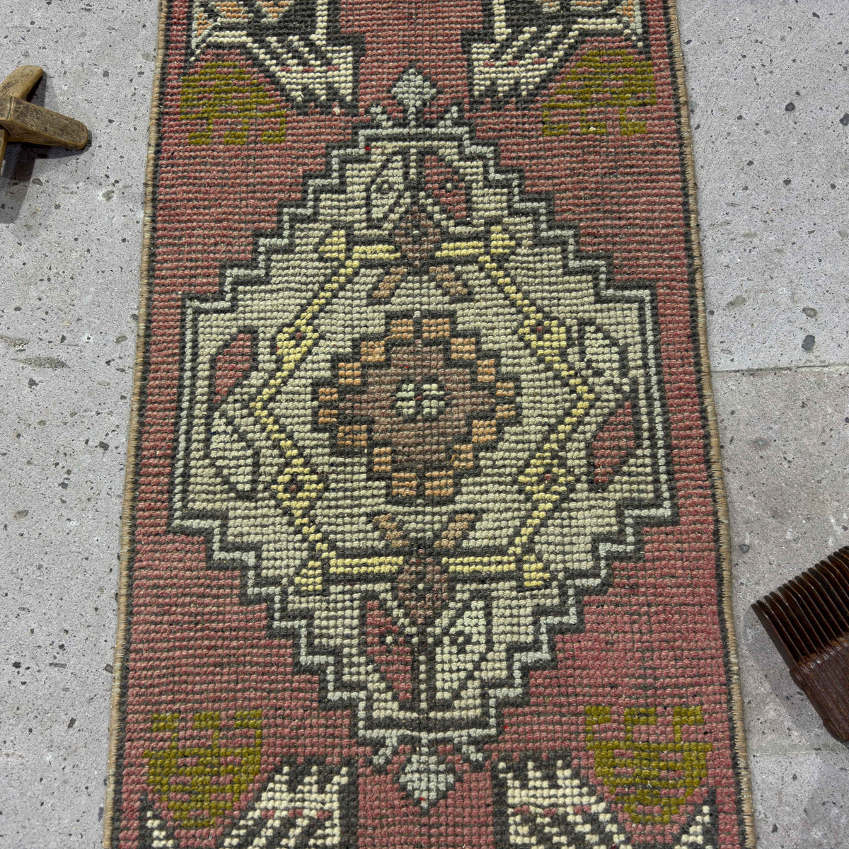 1970s red vintage Turkish mini rug with traditional design, hand-knotted weave and low pile.