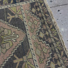 Close-up of the pink vintage Turkish mini runner showing traditional details, hand-knotted weave, wool and cotton and low pile.