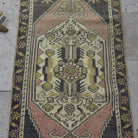 1970s pink vintage Turkish mini runner with traditional design, hand-knotted weave and low pile.