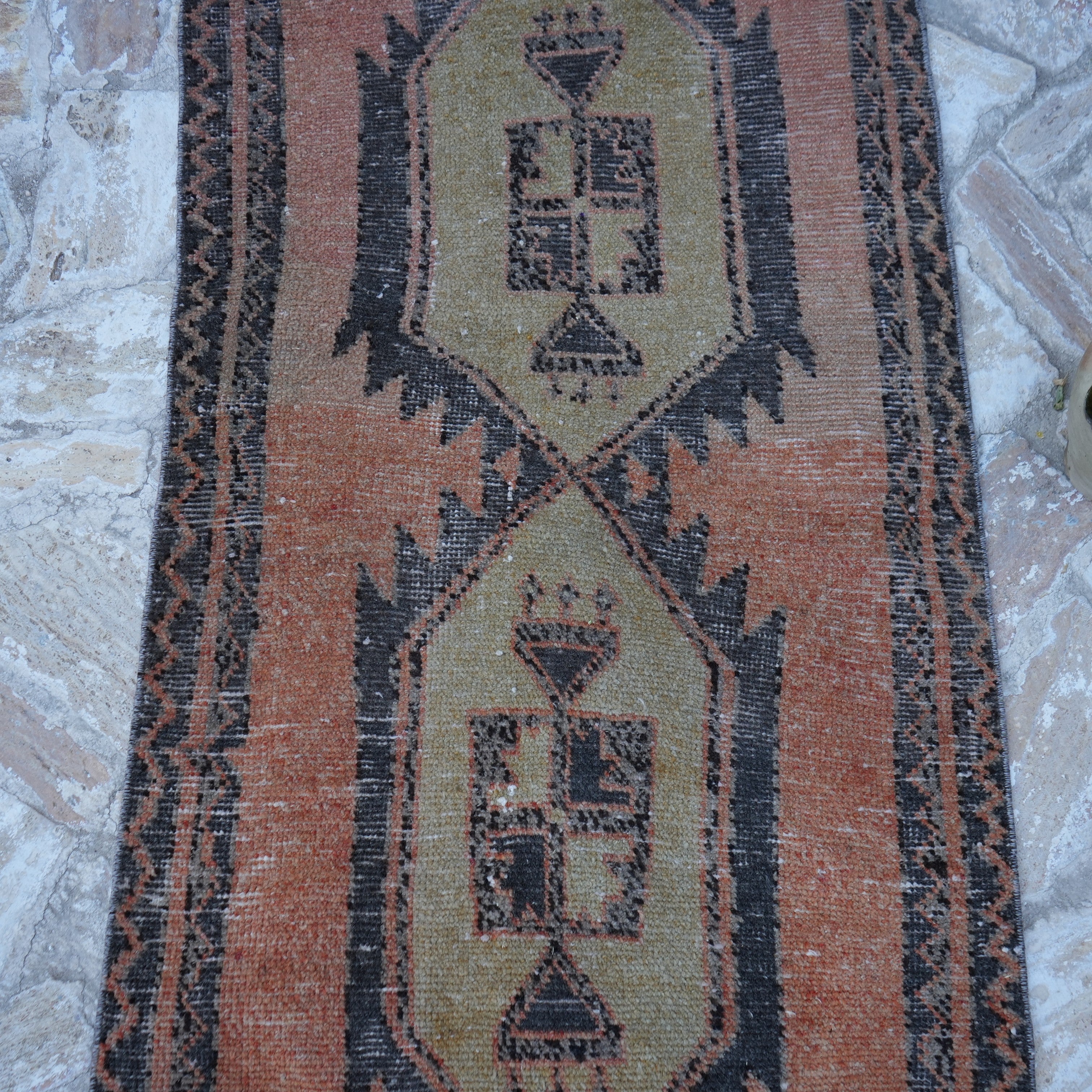 Close-up of the orange vintage Turkish mini runner showing traditional details, hand-knotted weave, wool and cotton and low pile.
