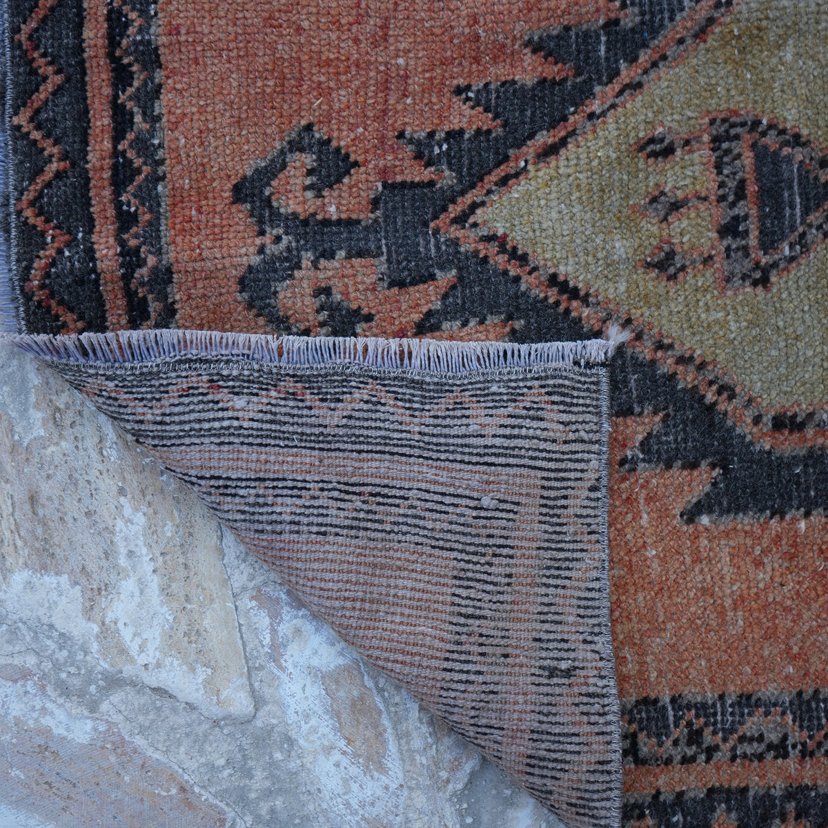 1970s orange vintage Turkish mini runner with traditional design, hand-knotted weave and low pile.