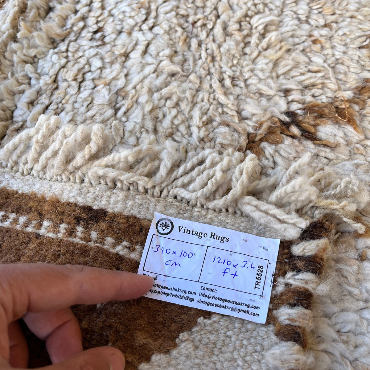 Close-up of the beige vintage Turkish morocco runner rug showing traditional details, hand-knotted weave, wool and cotton and large.
