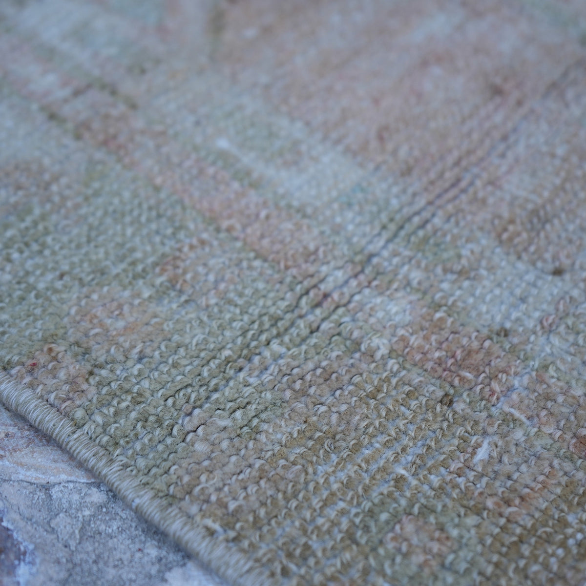 Pink 3' x 5' vintage Turkish neutral rug in wool and cotton, shown on the floor.