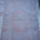 Close-up of the pink vintage Turkish neutral rug showing neutral details, hand-knotted weave, wool and low pile.