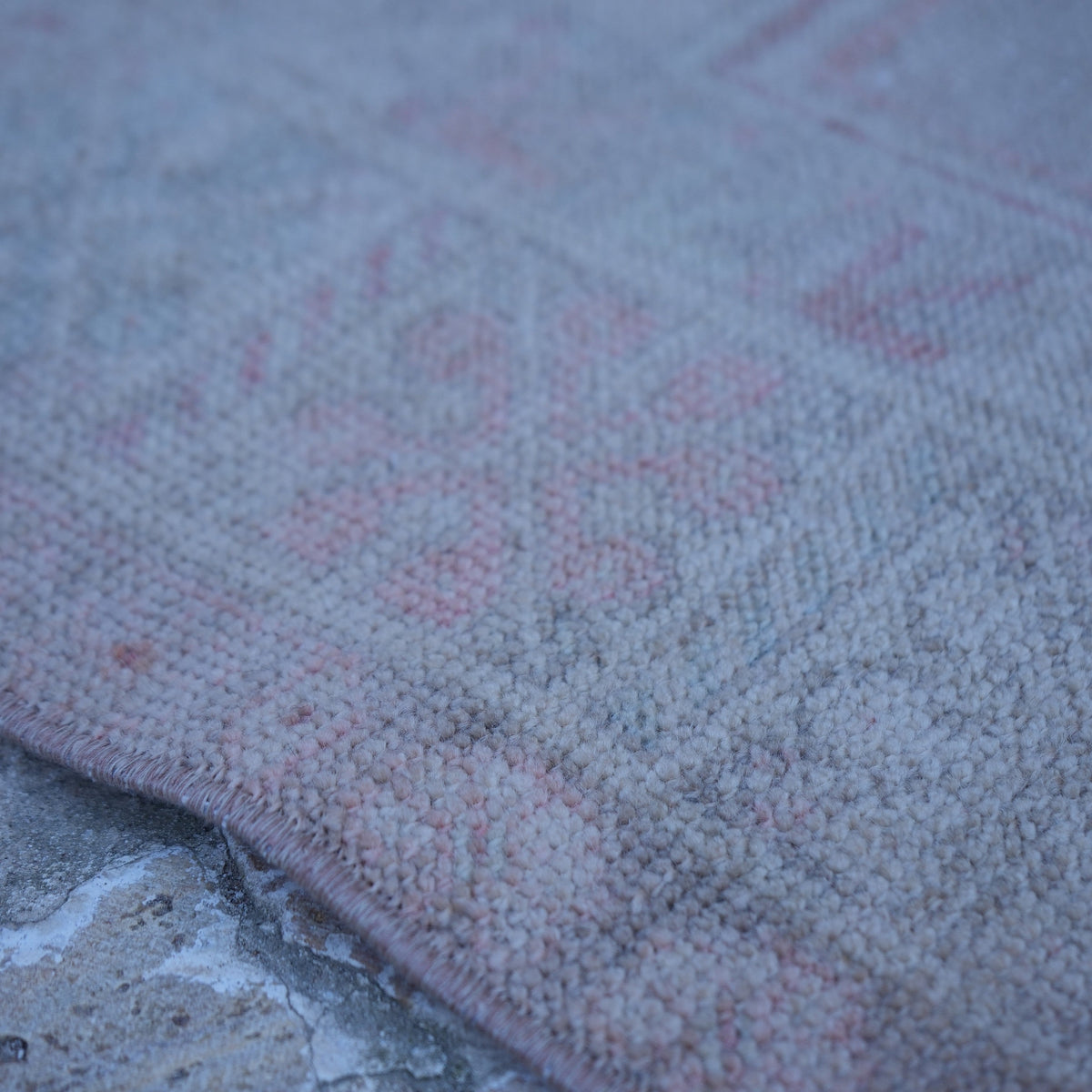 Pink 3' x 6' vintage Turkish neutral rug from the 1970s with neutral design.