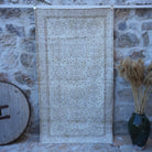Beige 4' x 7' vintage neutral rug with floral design, handmade in Turkey – Shell.