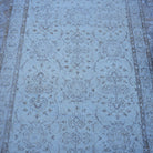 Close-up of the beige vintage Turkish neutral rug showing floral details, hand-knotted weave, wool and cotton and low pile.