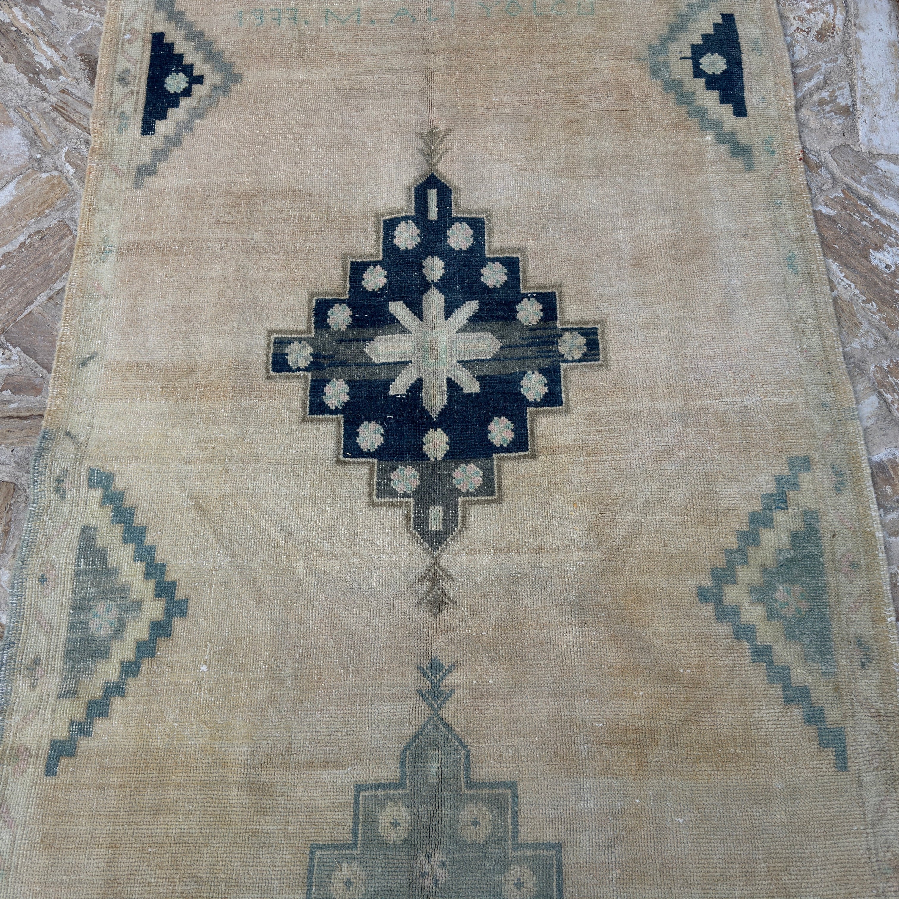 Beige 4' x 10' vintage Turkish neutral wool rug in wool and cotton, shown on the floor.