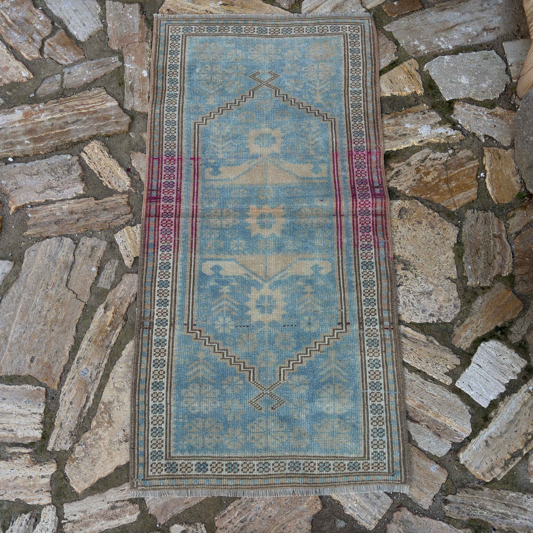 Pale Blue 2' x 4' vintage Turkish oriental rug in wool and cotton, shown on the floor.