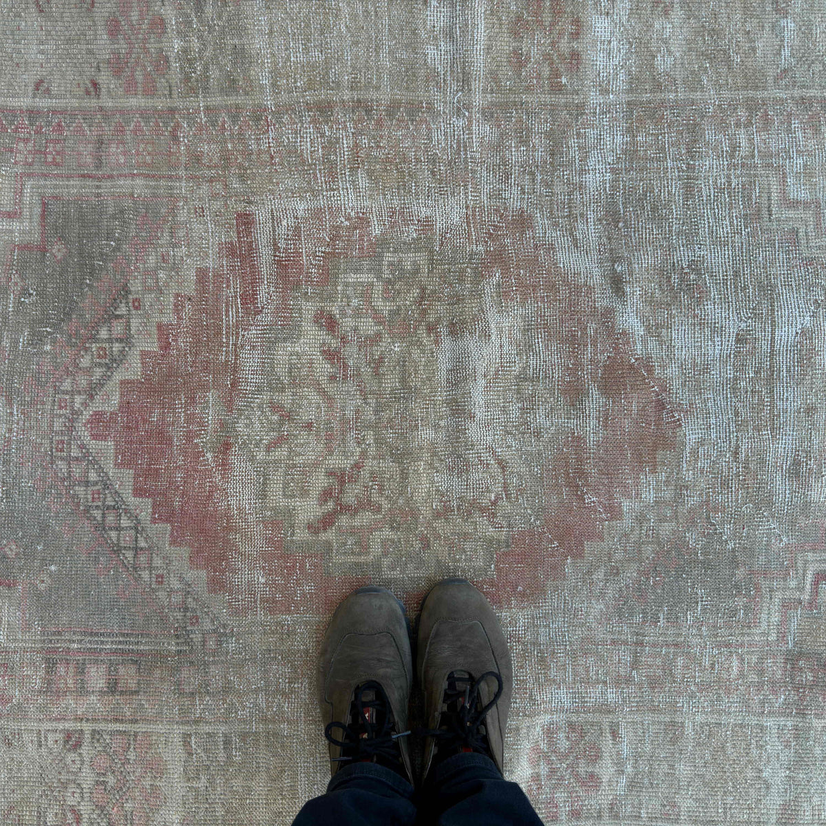 1970s pale red vintage Turkish oriental rug with neutral design, hand-knotted weave and low pile.