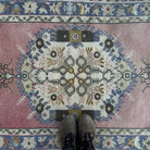 1970s pink vintage Turkish oriental rug with geometric design, hand-knotted weave and low pile.