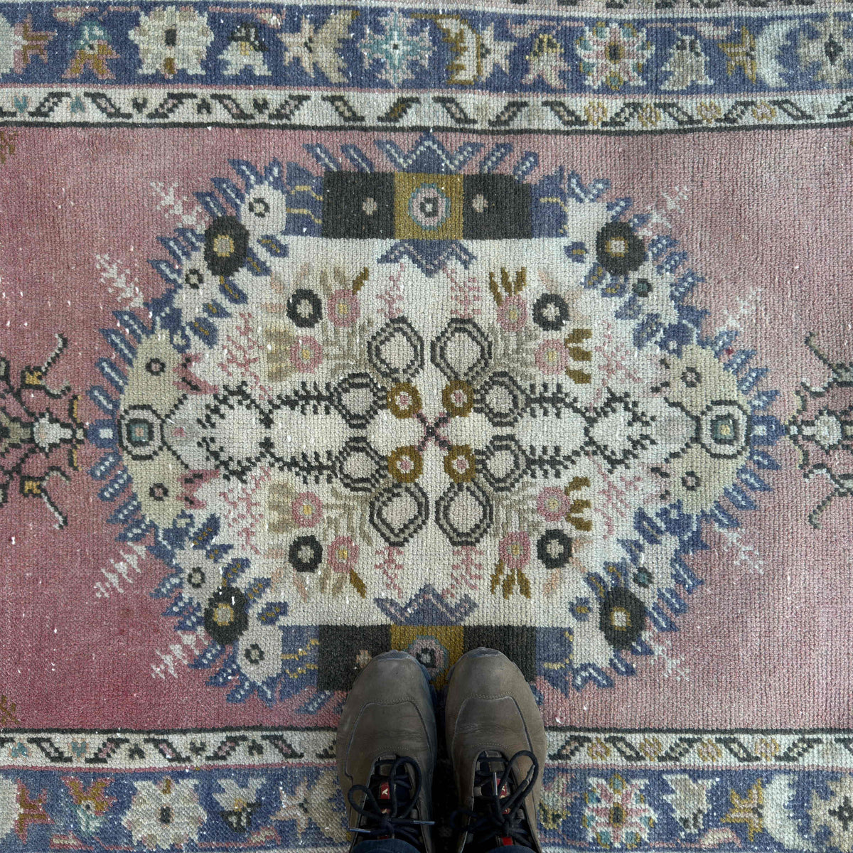 1970s pink vintage Turkish oriental rug with geometric design, hand-knotted weave and low pile.