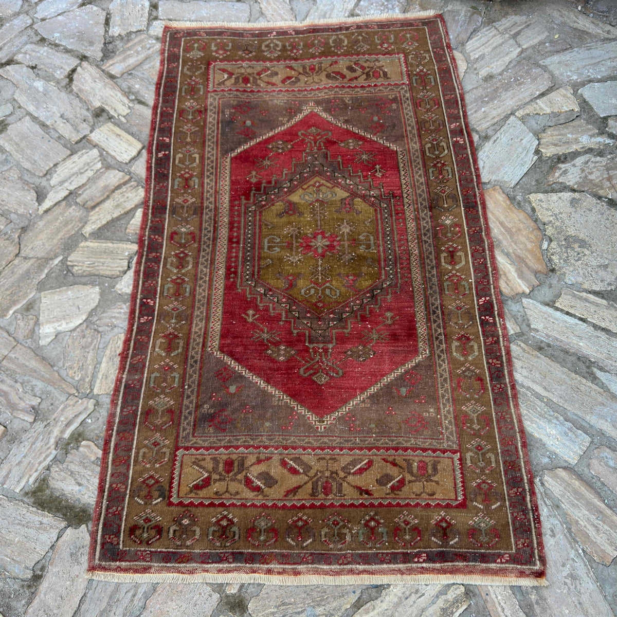 Red 3'x 6' vintage Turkish oriental rug in wool and cotton, shown on the floor.