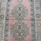 1970s pink vintage Turkish oriental rug with geometric design, hand-knotted weave and low pile.