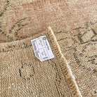 1970s beige vintage Turkish oriental rug with medallion design, hand-knotted weave and low pile.