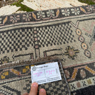 Close-up of the pink vintage Turkish oriental runner rug showing traditional details, hand-knotted weave, wool and cotton and low pile.