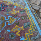 Close-up of the blue vintage Turkish oushak rug showing traditional details, hand-knotted weave, wool and cotton and low pile.