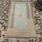 Blue 4' x 7' vintage Turkish oushak rug in wool and cotton, shown on the floor.