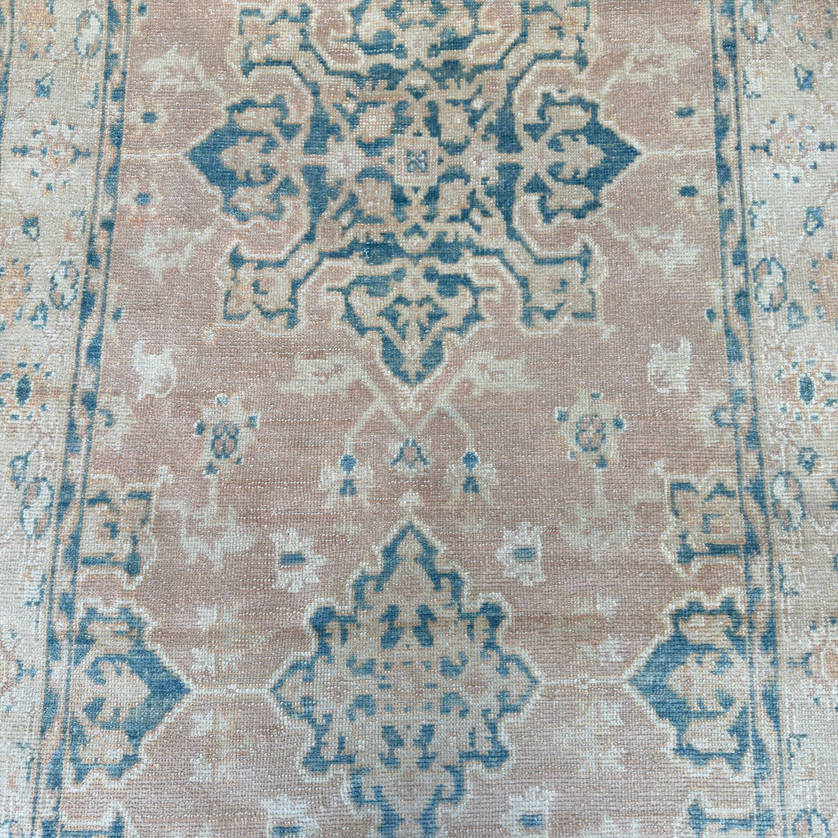 1970s pink vintage Turkish oushak rug with neutral design, hand-knotted weave and low pile.