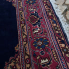 Close-up of the blue vintage Turkish oushak rug showing medallion details, hand-knotted weave, wool and cotton and low pile.