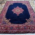 Blue 8' x 12' vintage Turkish oushak rug in wool and cotton, shown on the floor.