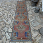 Pale Red 3' x 12' vintage Turkish oushak runner rug in wool and cotton, shown on the floor.