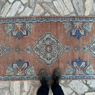 1970s pale red vintage Turkish oushak runner rug with oushak design, hand-knotted weave and low pile.