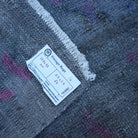 Black 1' x 3' vintage Turkish overdyed rug from the 1970s with overdyed design.